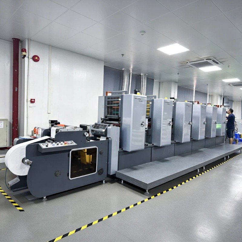 Roll-fed printing press in a label production workshop